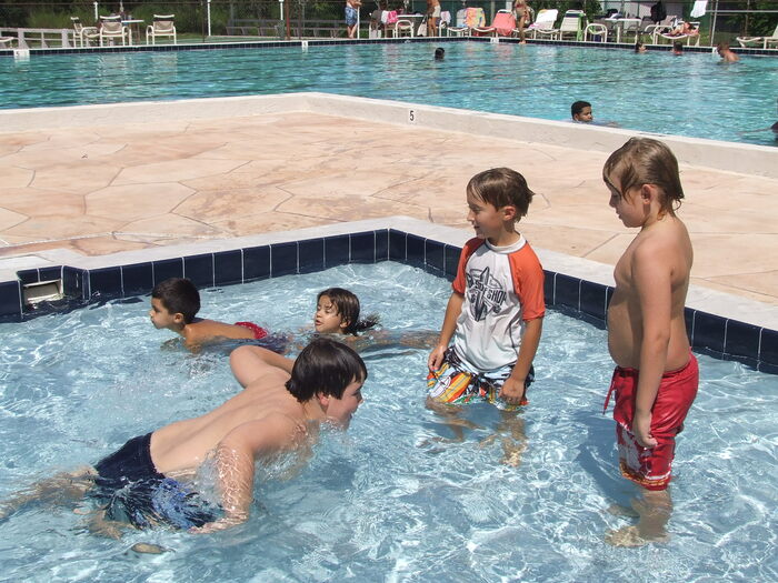 Children swimming and playing in a swimming pool 